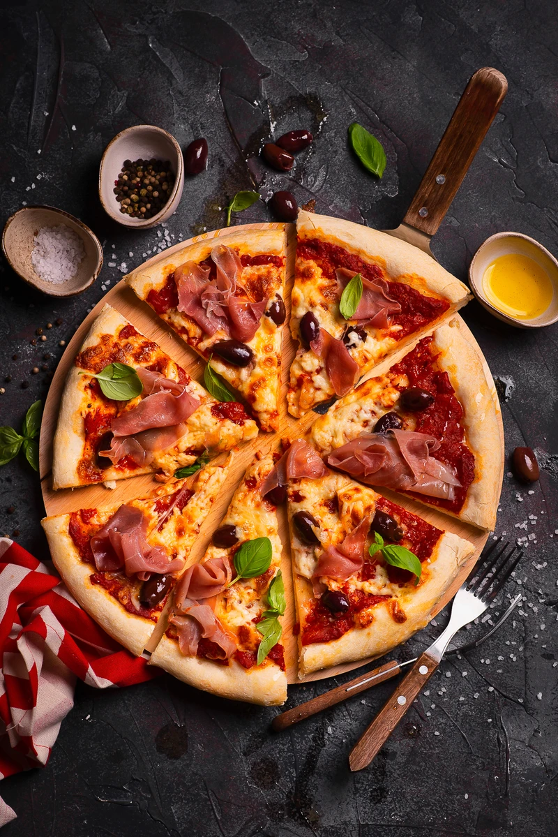 Domowa pizza z szynką parmeńską, oliwkami i mozzarellą