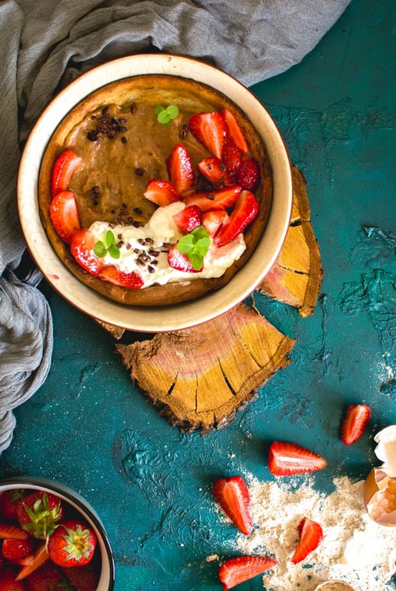 Pełnoziarnisty dutch baby z musem rabarbarowym i truskawkami