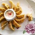 Pierogi z ciasta dyniowego nadziane dynią i słonym serem